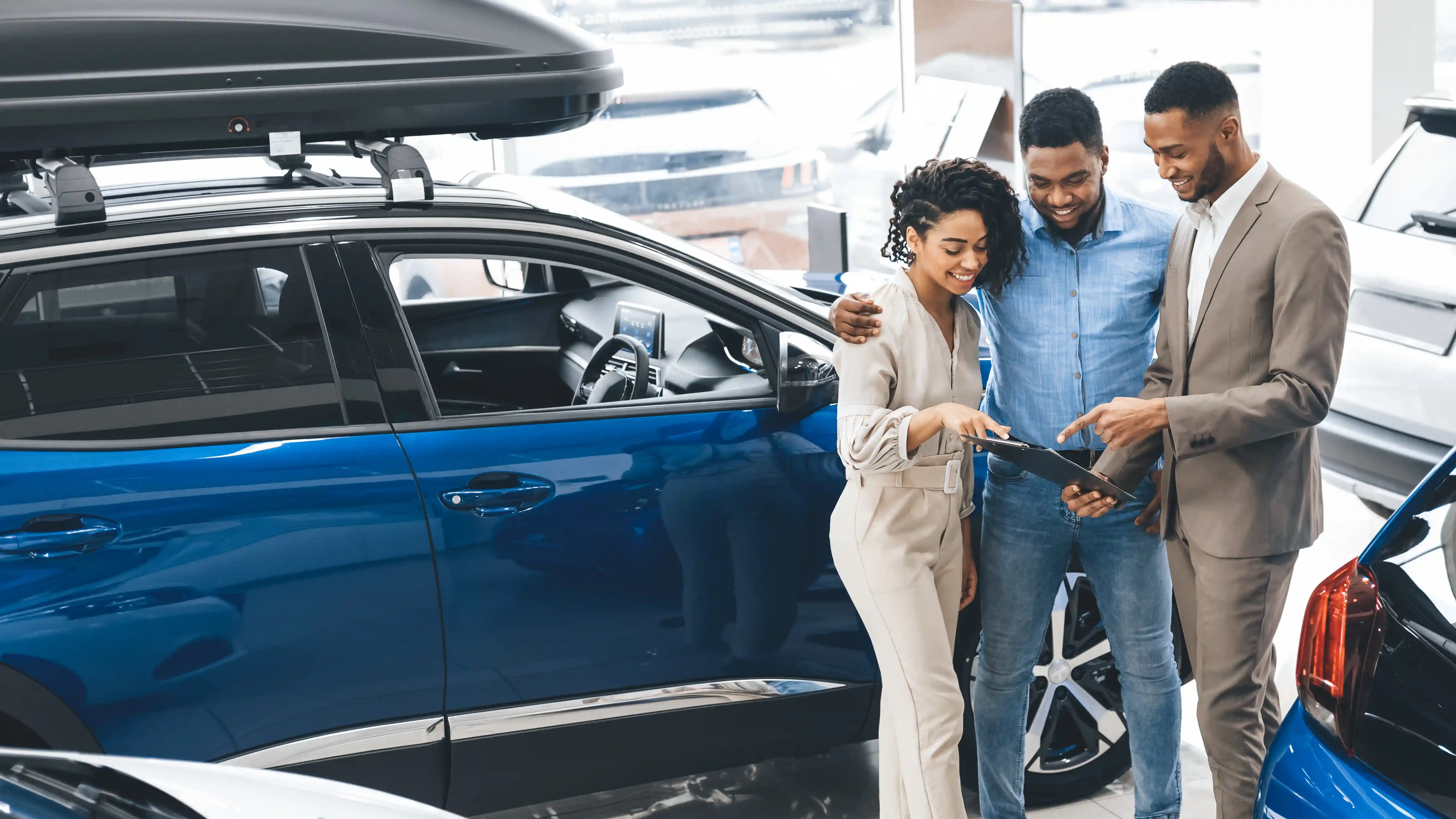 a couple shopping for a new vehicle at a dealership