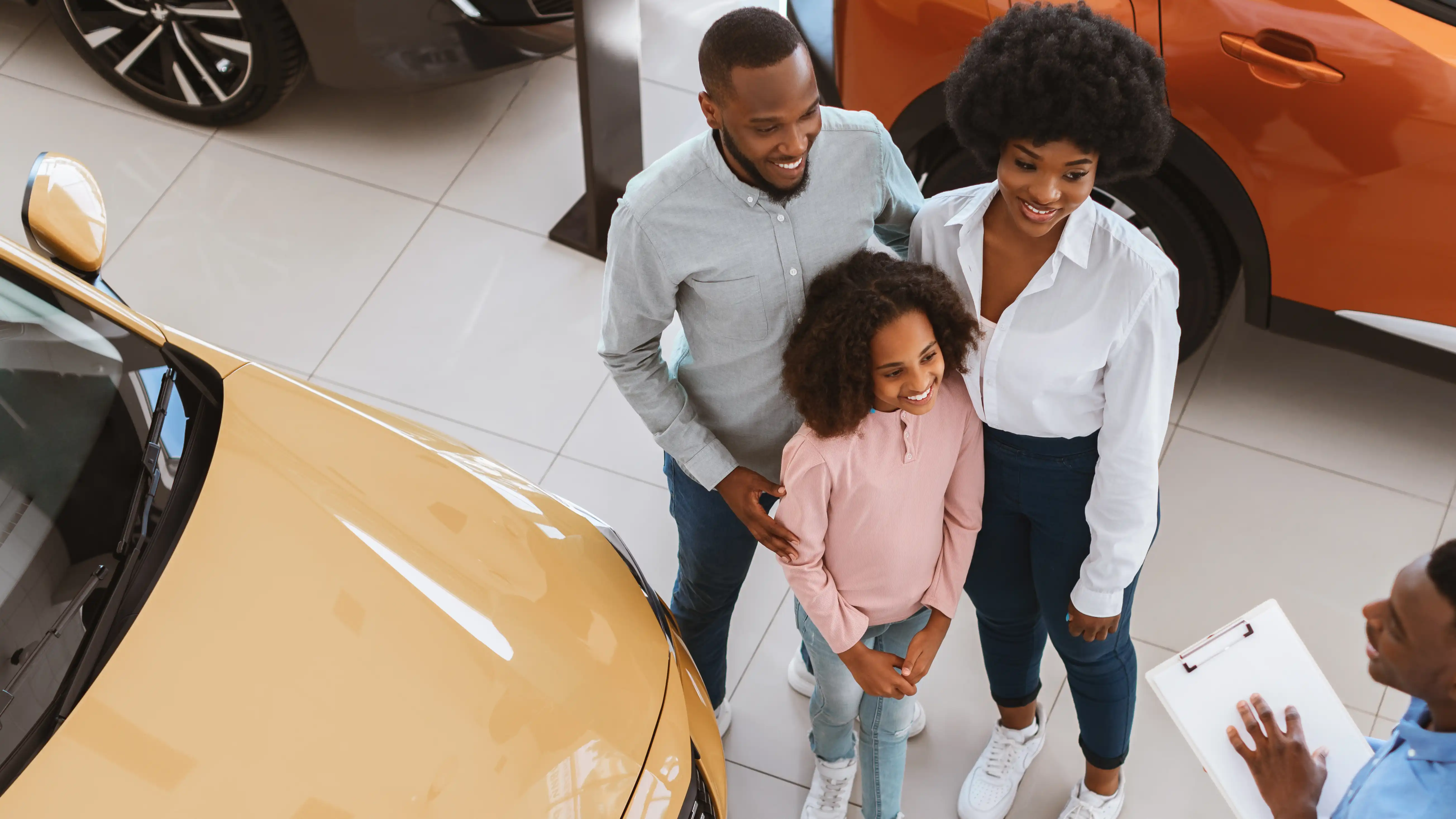 a couple shopping for a new vehicle at a dealership